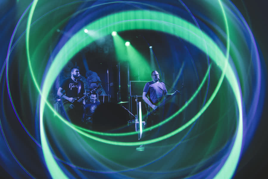 The band framed by green laser circles